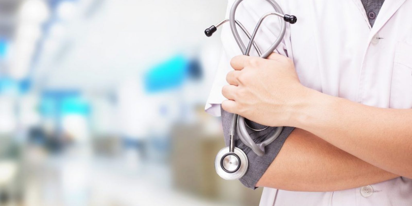 Doctor with a stethoscope in the hands and hospital background