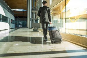 businessman back and lengs walking with luggage at the airport