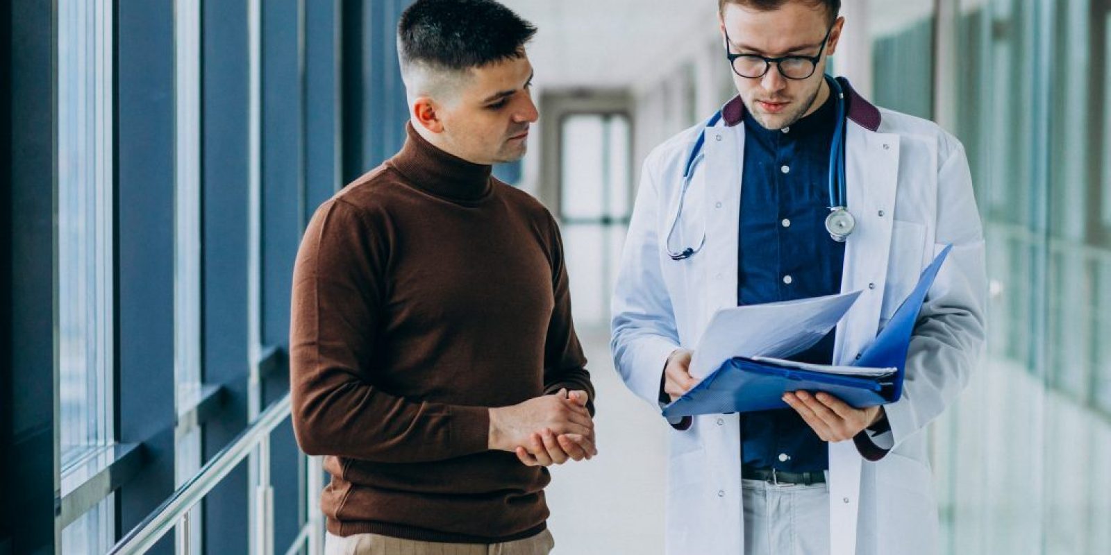 Doctor talking with his patient at clinic