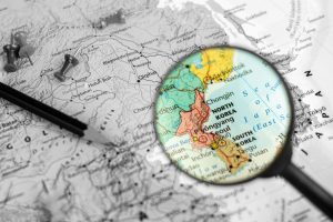 note device and magnifier selective at north korea and south korea map. - economic and travel concept.