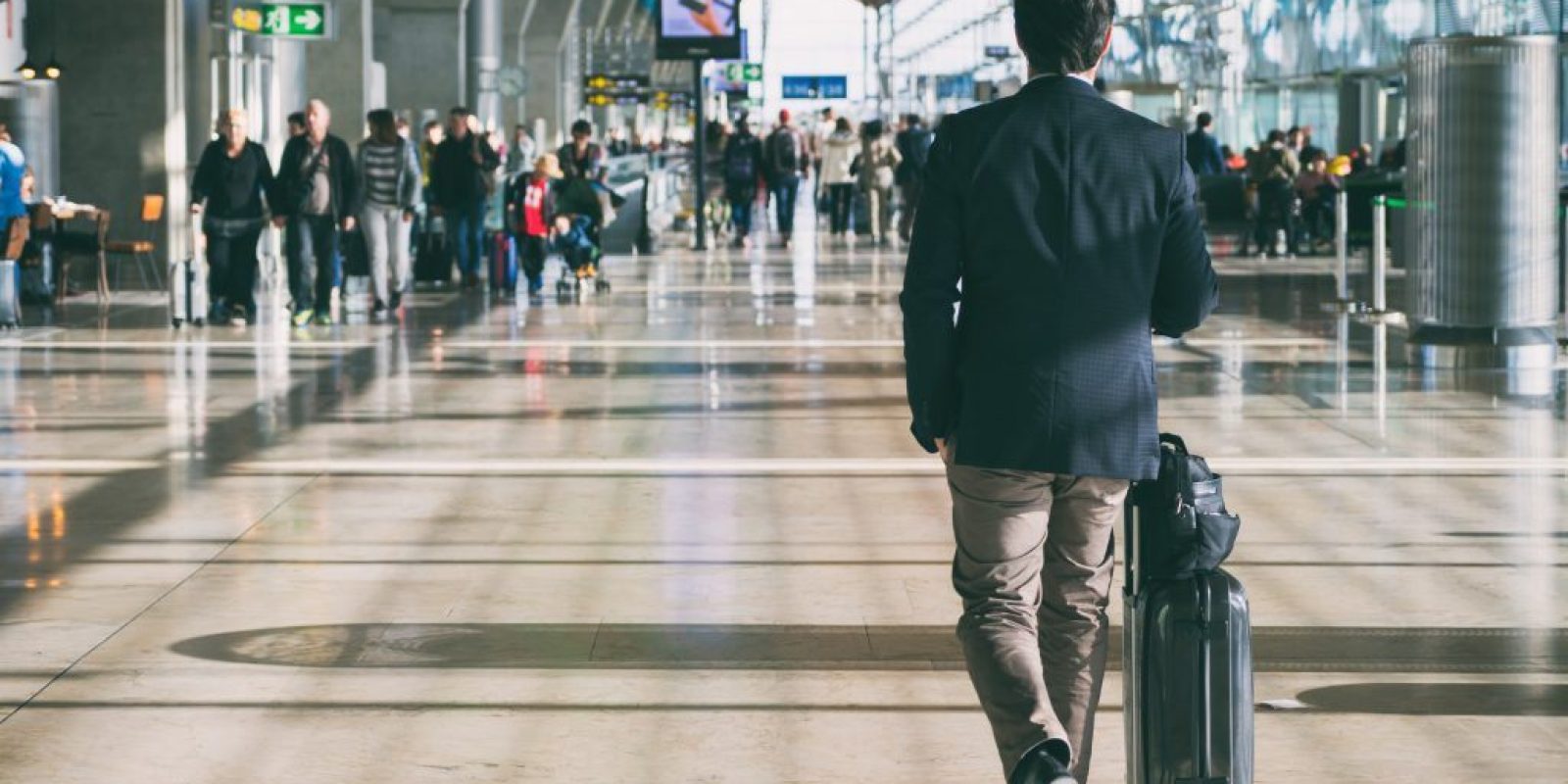 Close up of businessman carrying suitcase while walking through