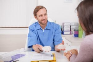 Plastic surgeon showing breast implants to a patient